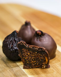 Dark chocolate covered figs cut in half.